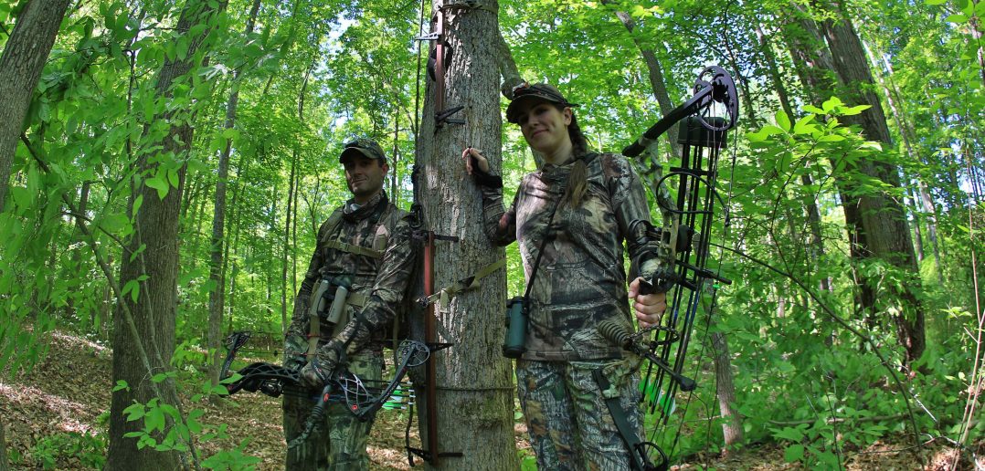 man and woman bowhunting