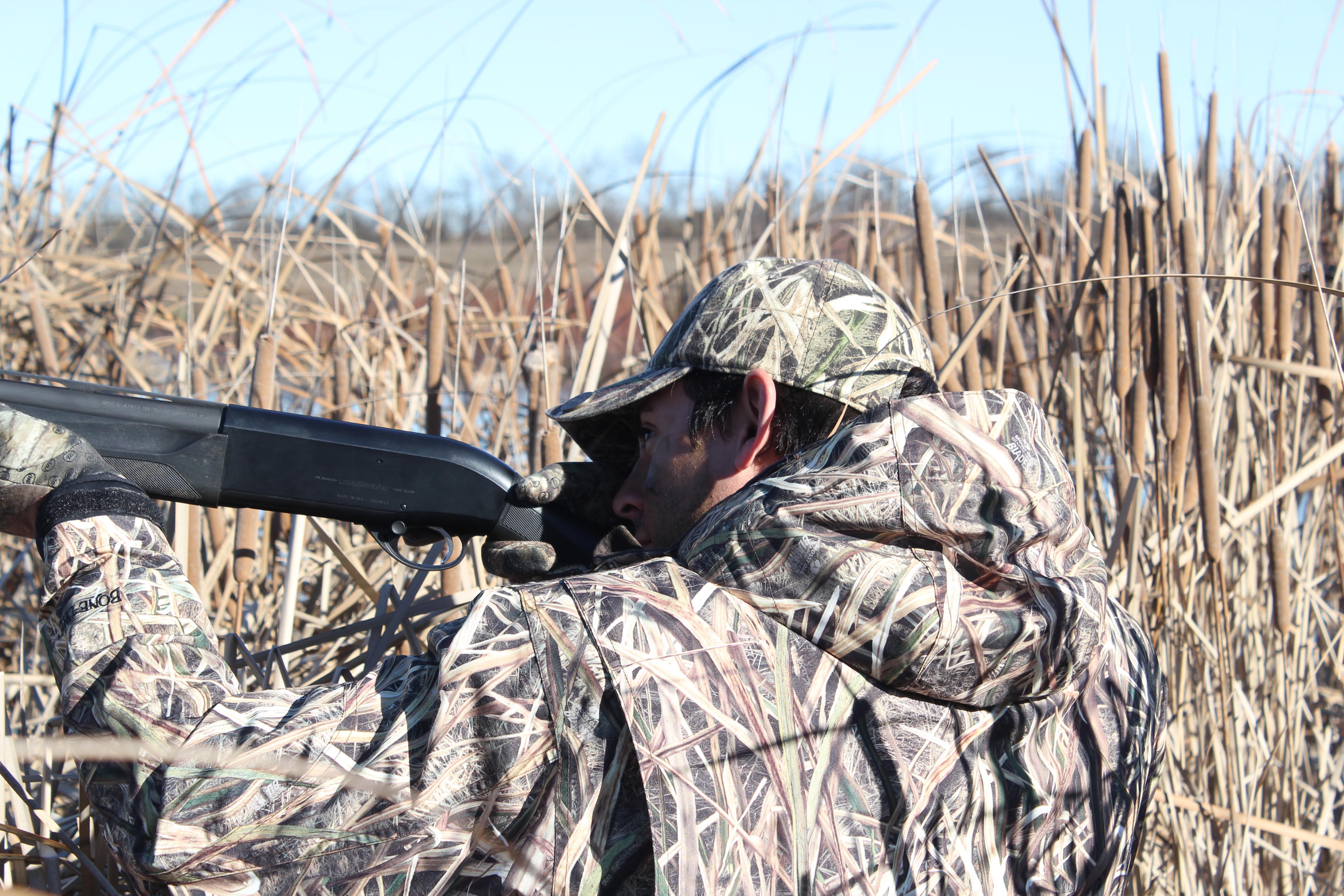Man hunting ducks in a field